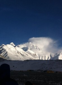 The majestic North Face of Mt Everest bathed in evening sunlight. Masking the tragedy unfolding behind.