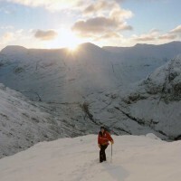 Chris-approching-the-firs-summit-in-the-dawn-sun