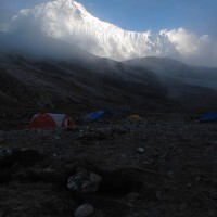 Camp with Cholatse shimmering behind.